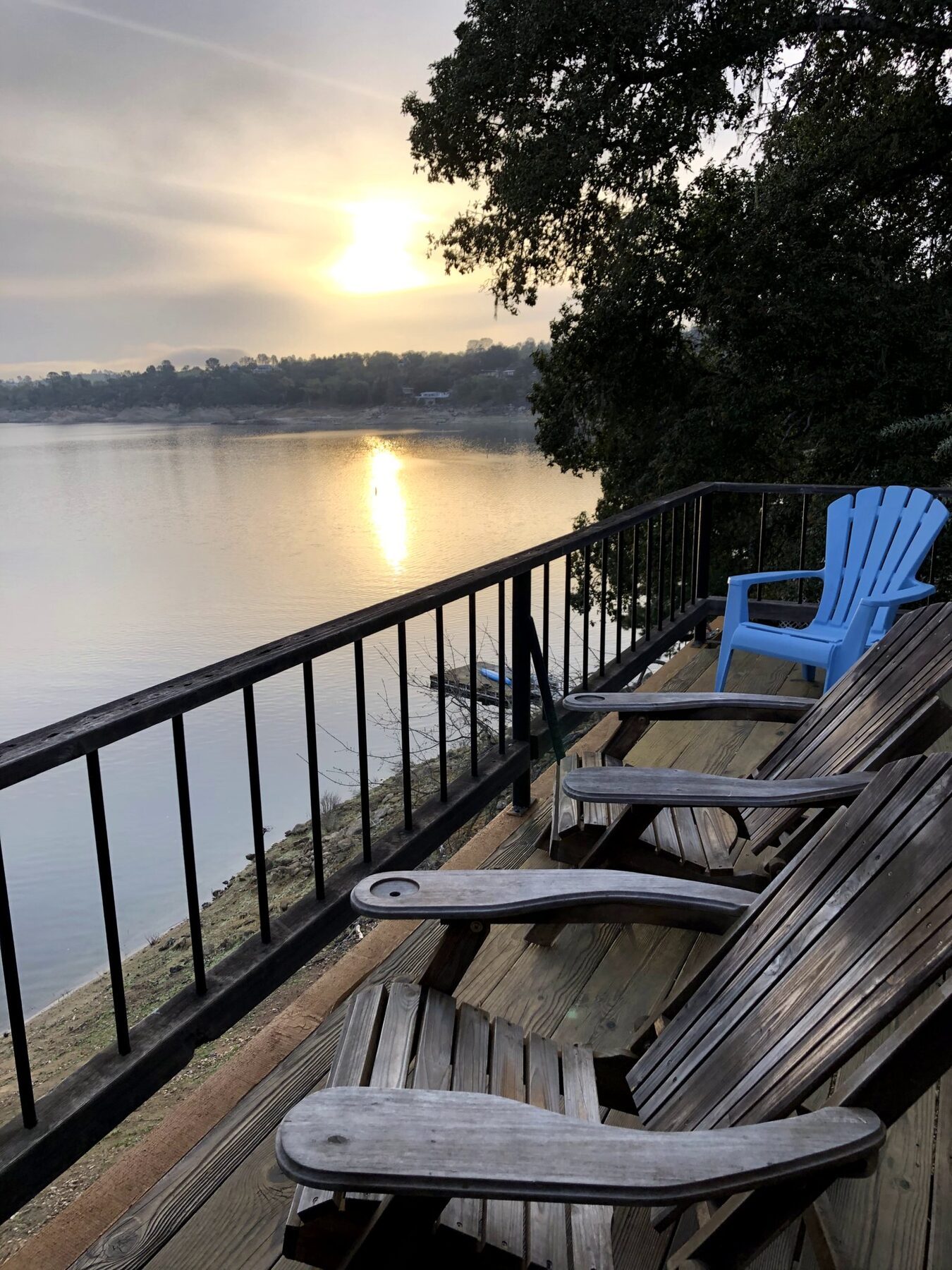 Deck chairs facing the sunrise over the lake