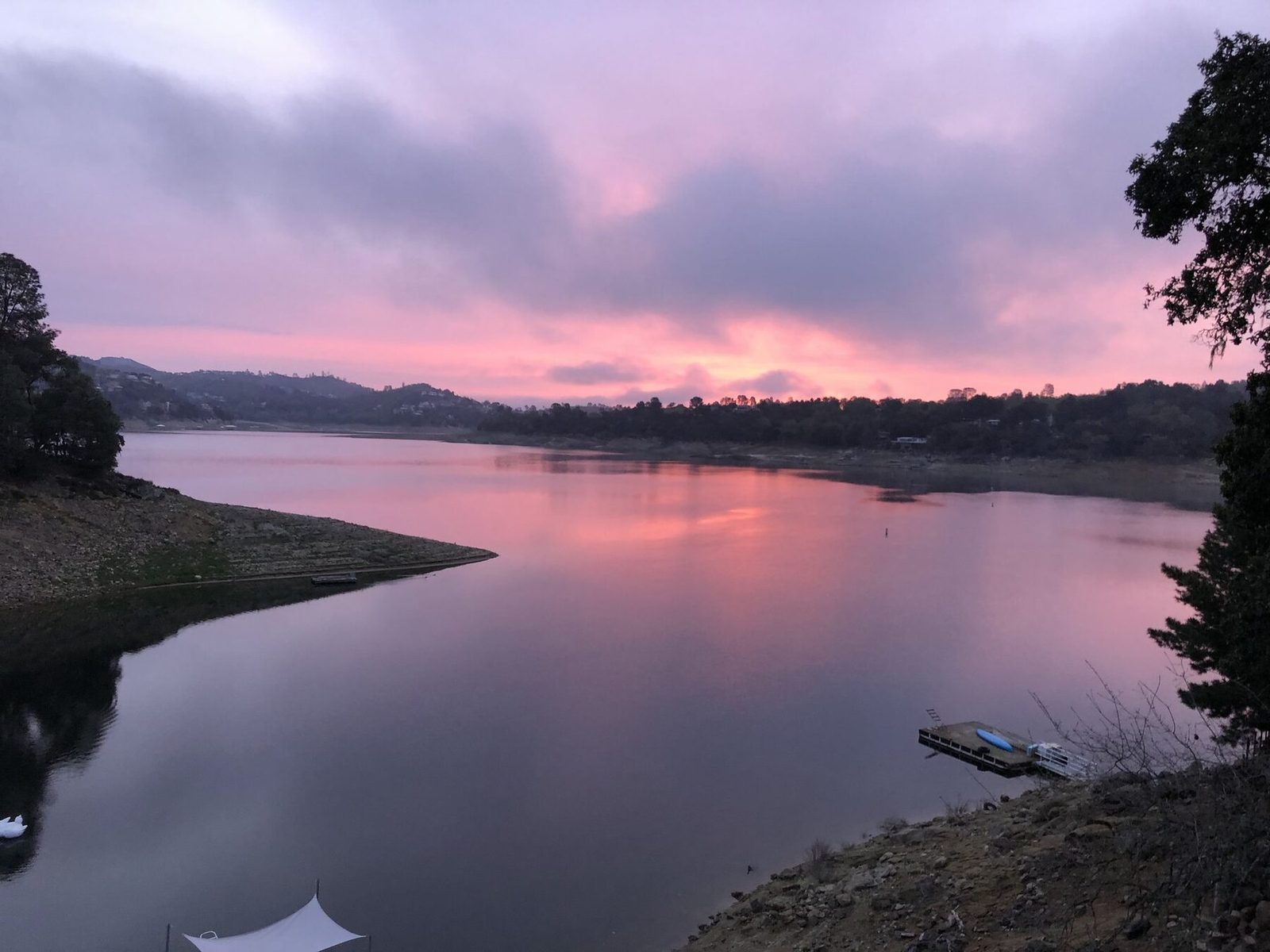 Pink sunrise sky reflected on the lake